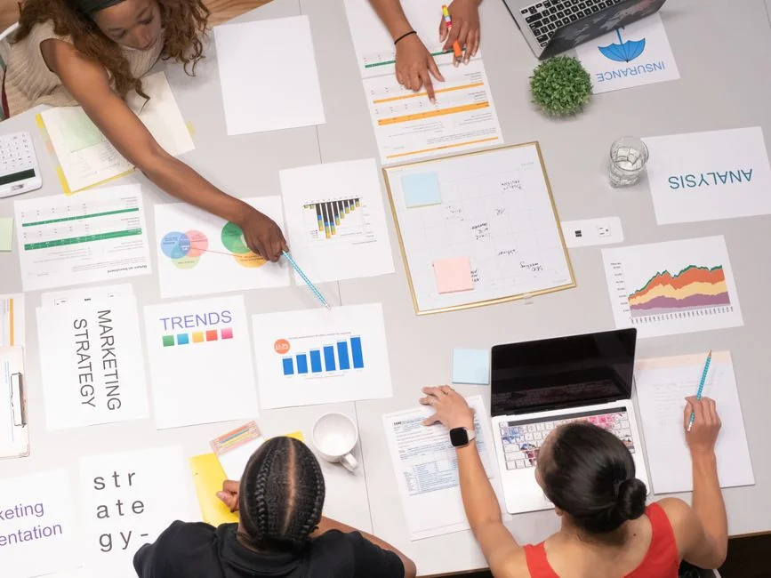 Une équipe examine des graphiques financiers et des données numériques sur des tablettes dans un bureau.