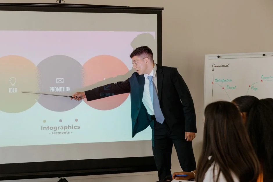 Person analyzes stock data with a smartphone and laptop, indoors.